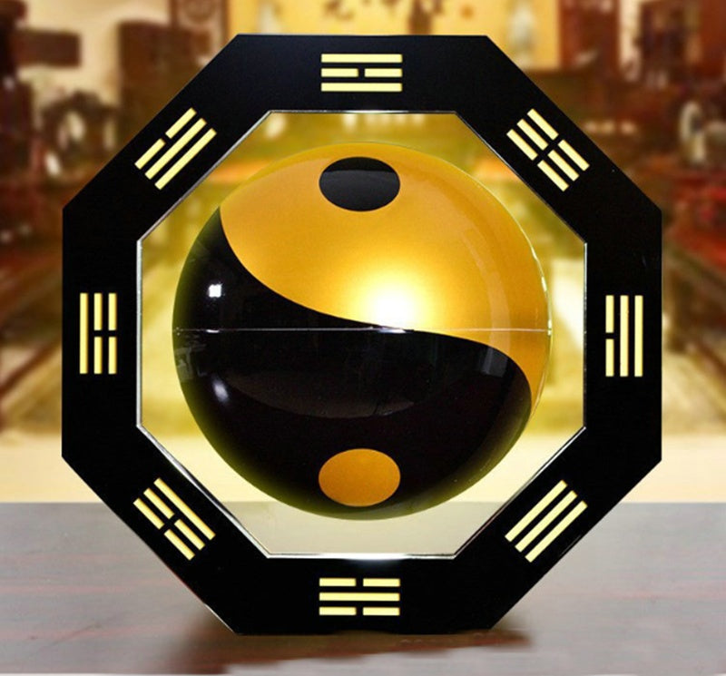 Yin and yang symbol in a decorative frame with八卦 patterns on a blurred background