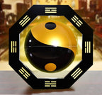 Yin and yang symbol in a decorative frame with八卦 patterns on a blurred background