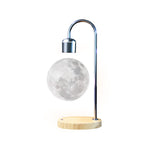 Levitating moon lamp with wooden base on a white background