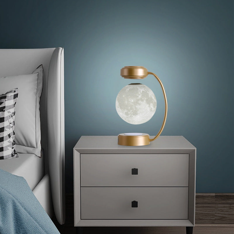 Modern nightstand with a decorative lamp against a dark blue wall.