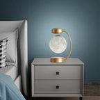 Modern nightstand with a decorative lamp against a dark blue wall.