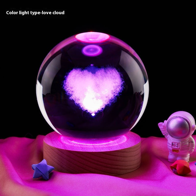 Crystal ball with heart-shaped light inside on a dark background
