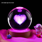 Crystal ball with heart-shaped light inside on a dark background