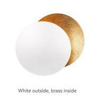 Light fixture with white outside and brass inside on a white background