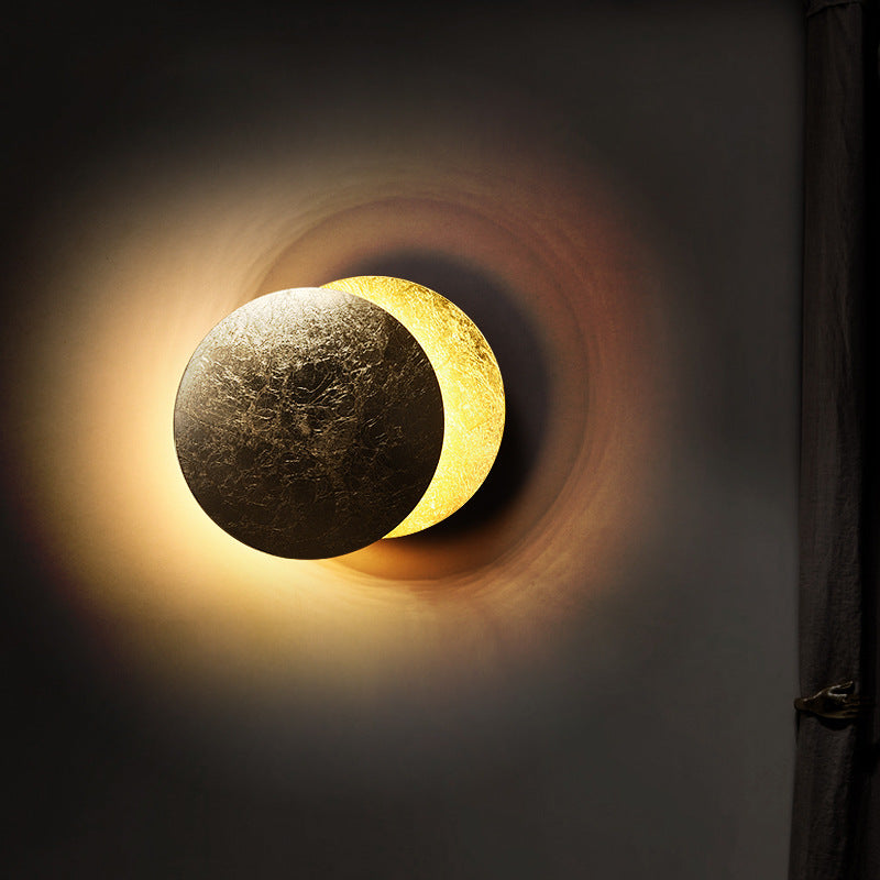 Artistic depiction of a solar eclipse with a darkened moon and a bright sun on a dark background.