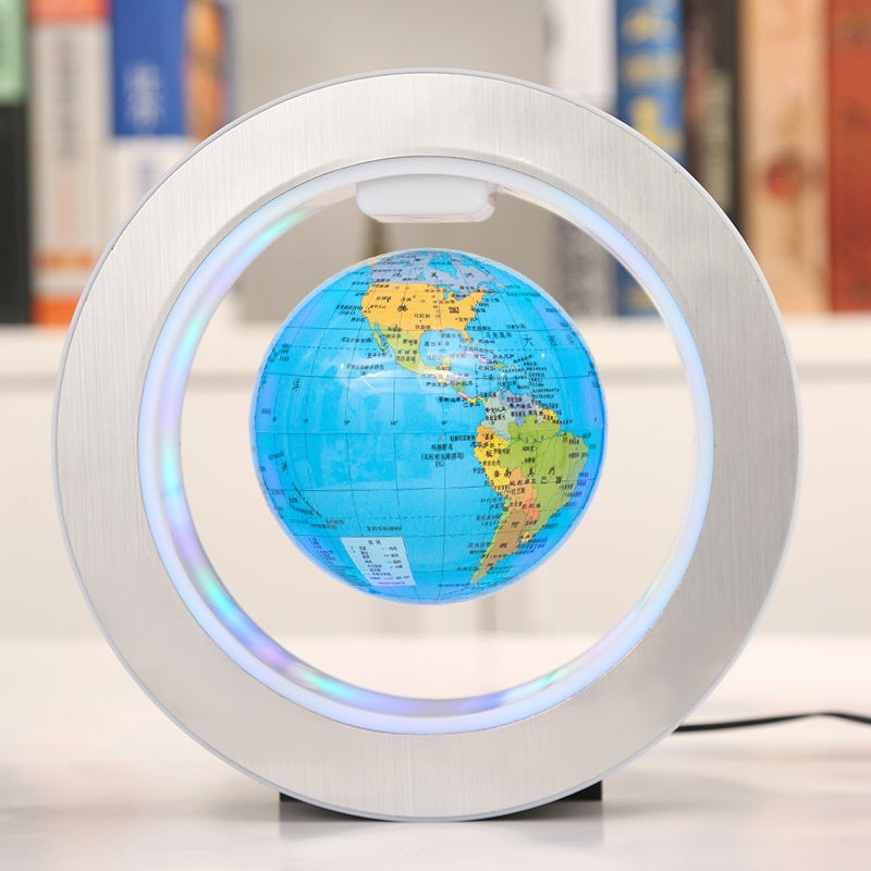 Levitating globe with colorful world map on a white surface