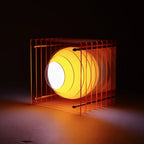 Drum set inside a cage with a dark background