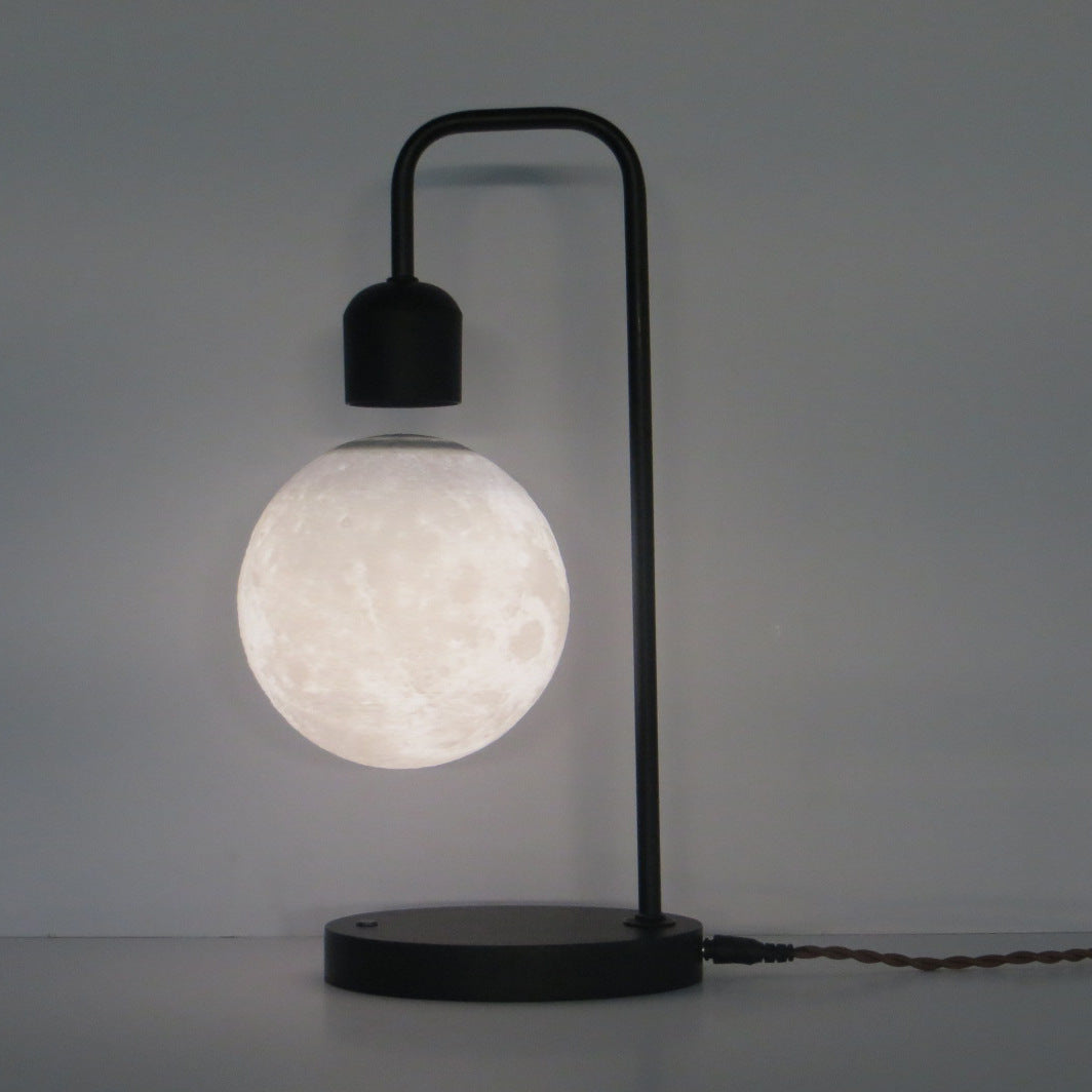 Modern table lamp with a spherical white bulb on a gray background