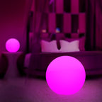 Pink glowing ball in a room with blurred background