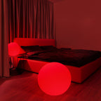 Red-themed bedroom with a bed and glowing red sphere.