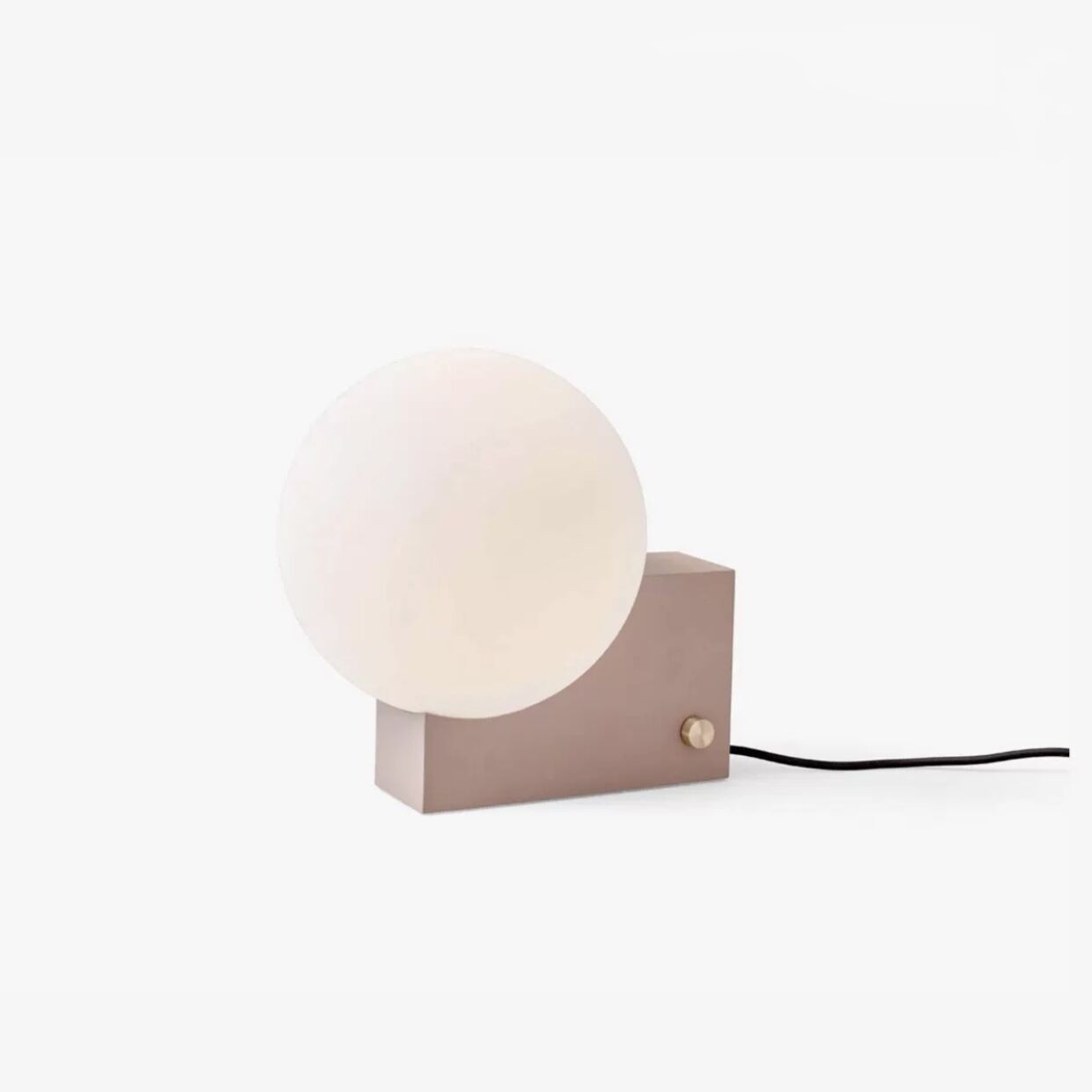 Modern wall-mounted lamp with a round white shade on a light beige base against a white background.