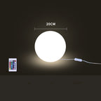 Glowing round light with remote control on a dark background
