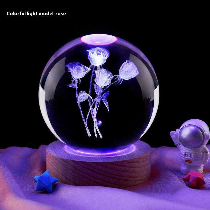 Crystal ball with colorful light display of roses on a dark background