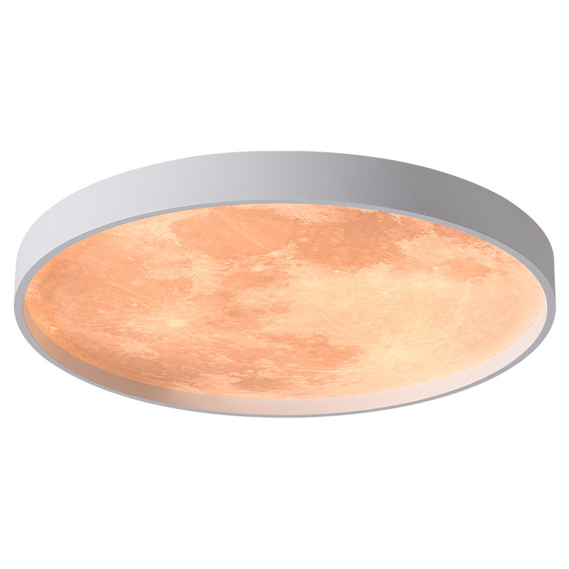 Round ceiling light fixture with a metallic frame and warm-toned glass on a white background