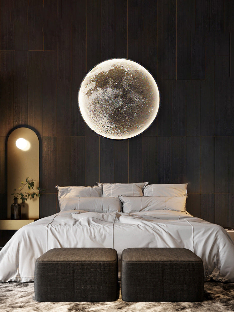 Bedroom with a large moon wall art piece on a dark wooden wall.