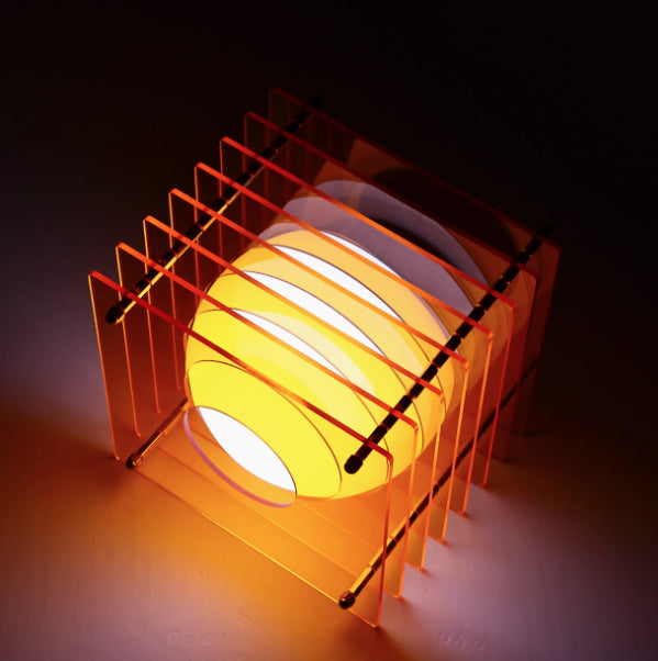 Light bulb with orange metal cage on a dark background
