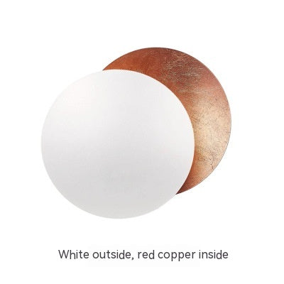 Round object with white exterior and red copper interior on a white background