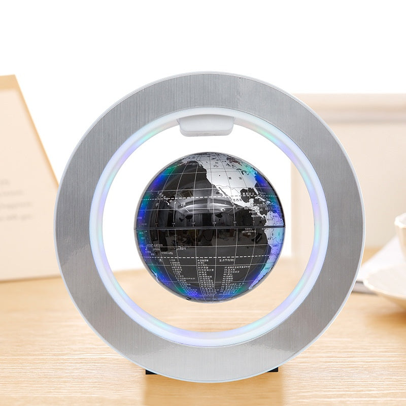 Levitating globe with LED light on a wooden surface