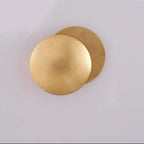 Gold wall sconce on a light gray background