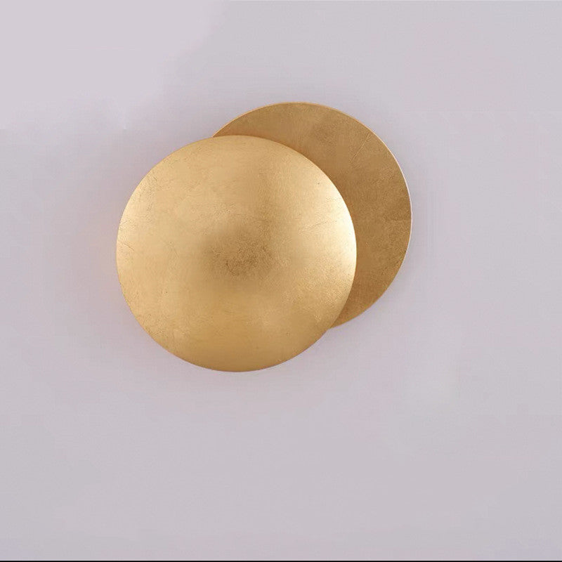 Gold wall sconce on a light gray background