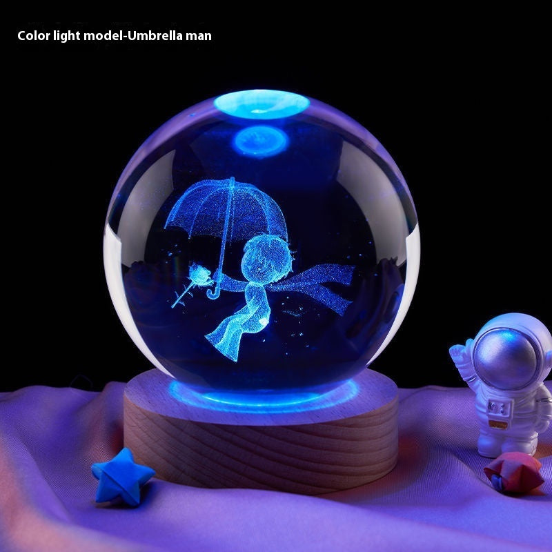 Crystal ball with blue light projection of an umbrella man figure on a wooden base.